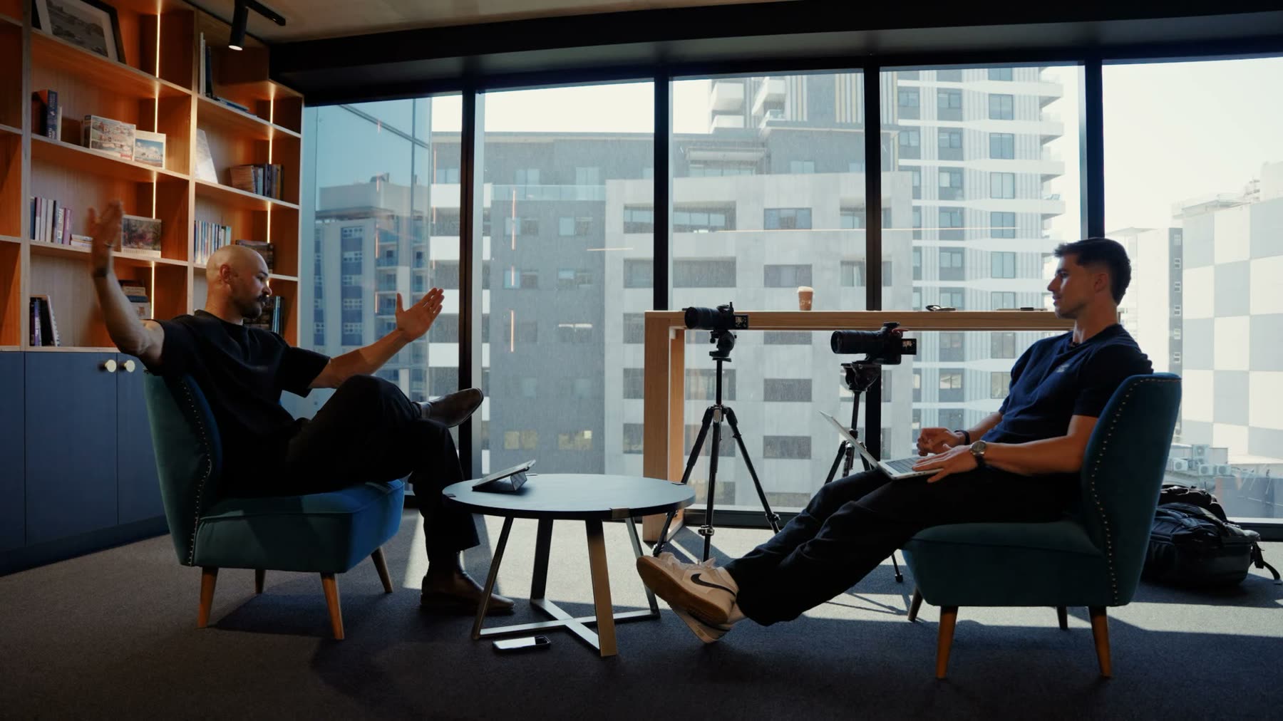 Two-camera podcast shoot in a city office, a founder mid-conversation